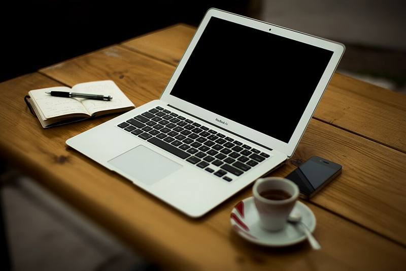 A laptop on a desk in a home office